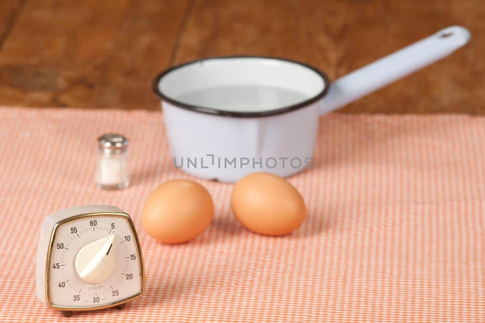Two eggs with pot and egg timer
