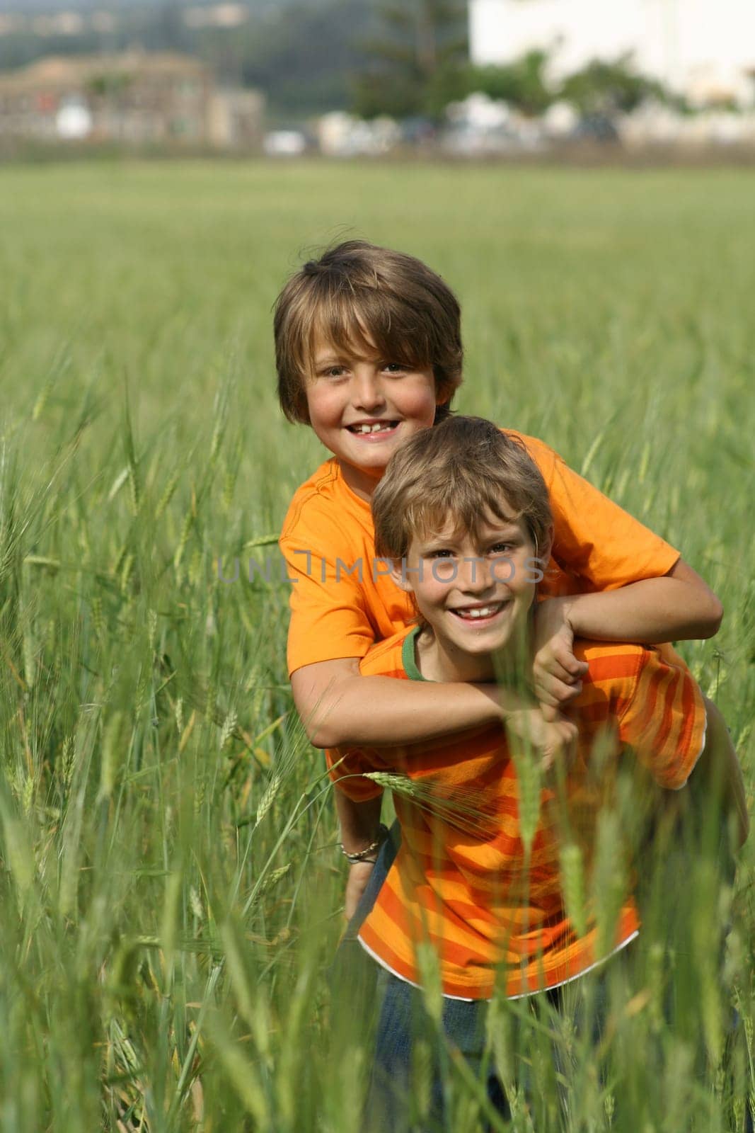 happy healthy fit active children or kids playing piggyback outdoors