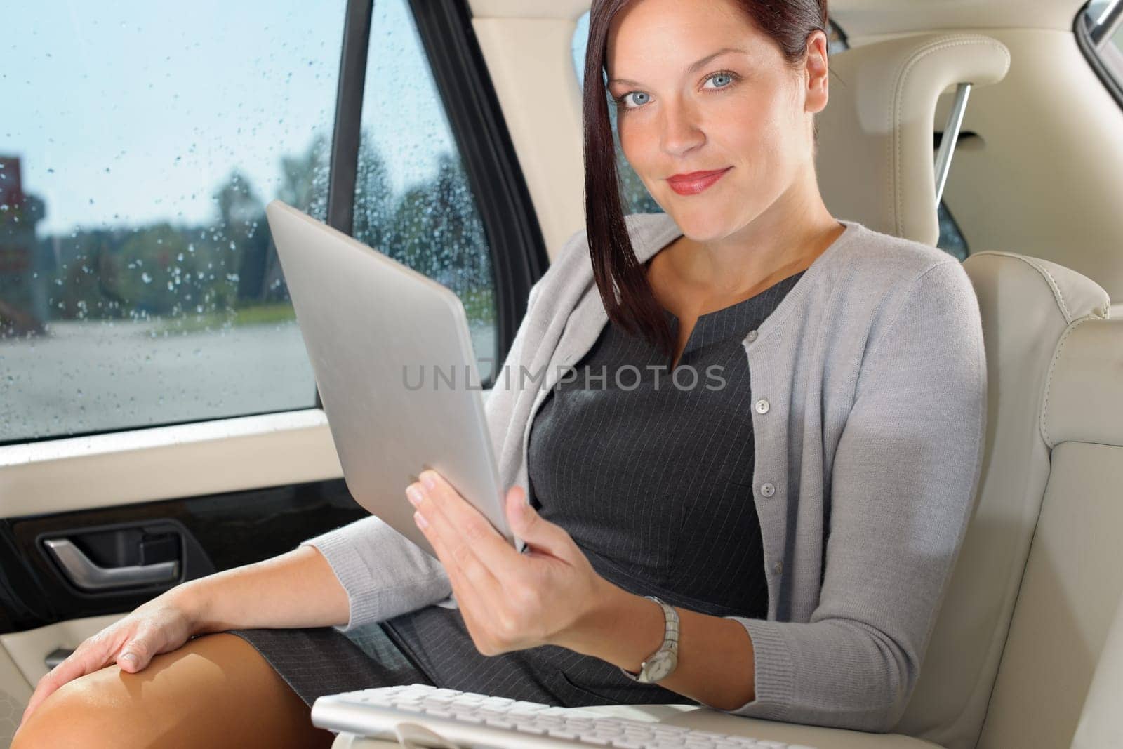 Attractive executive female manager work luxury car touch tablet computer