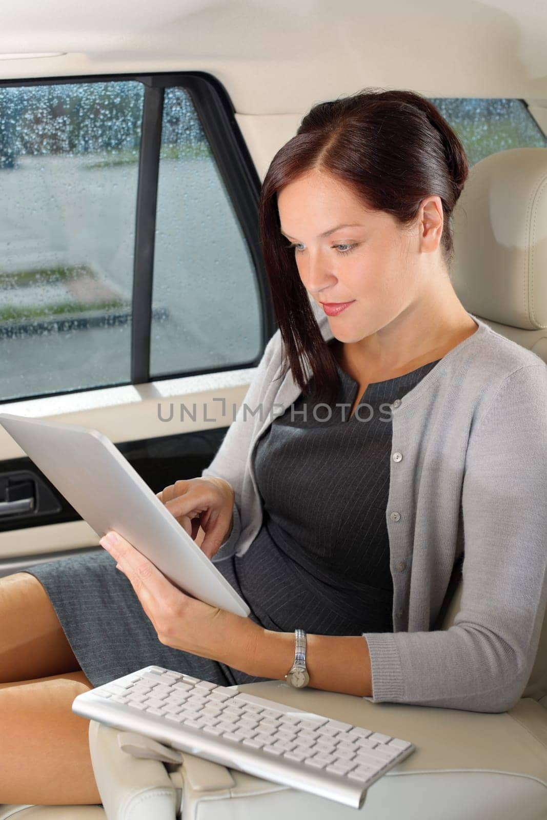 Attractive executive female manager work luxury car touch tablet computer