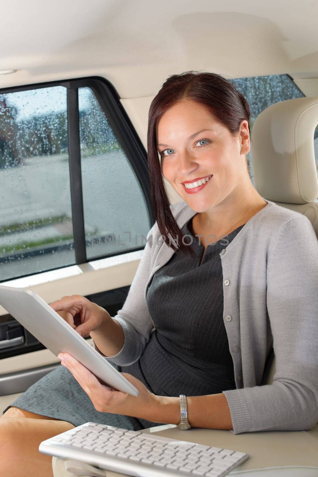 Attractive executive female manager work luxury car touch tablet computer