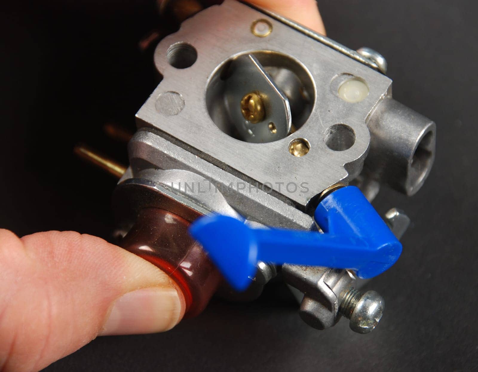 Stock pictures of a small gas engine and a carburetor