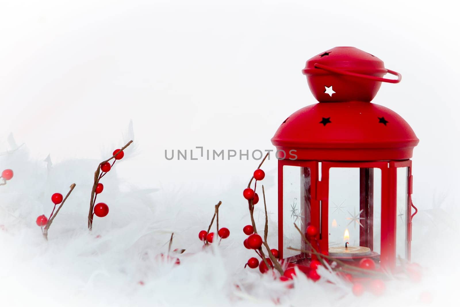 christmas decoration,candle lamp, holly berries and snow