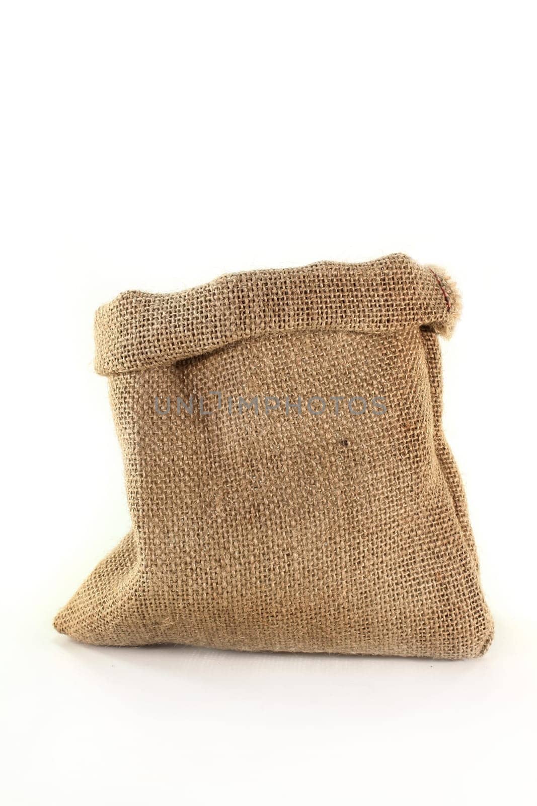 An empty jute sack against a white background