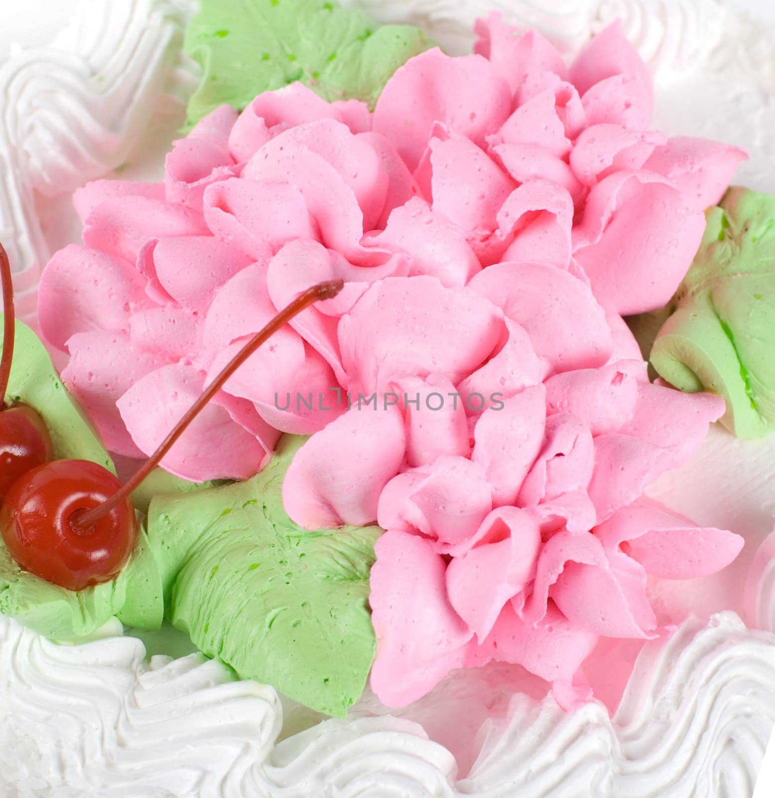 cream cake closeup with cherry on a grey