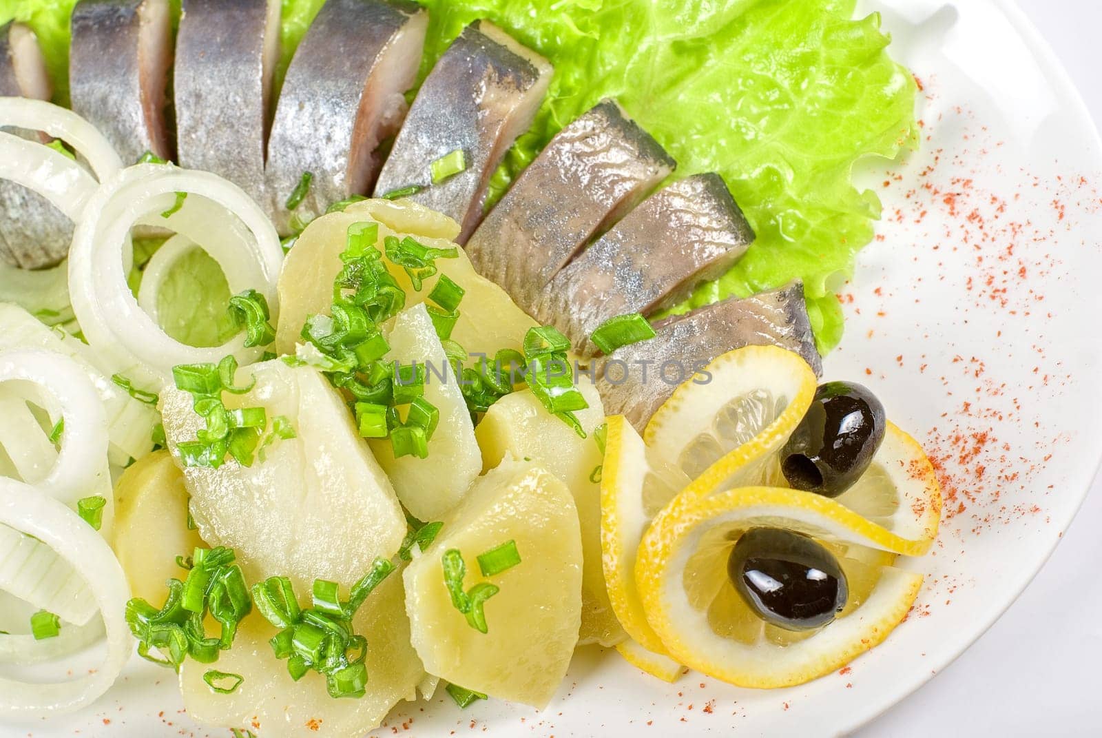 Tasty herring with potato and fresh vegetables