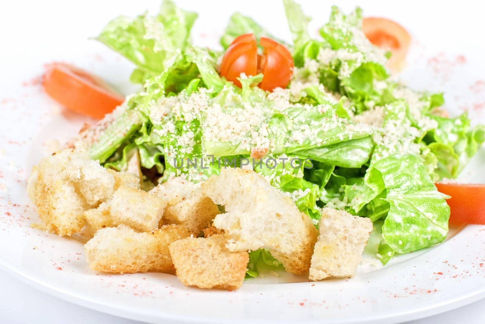 salad of meat, vegetable and dried crust dish close up on a white background