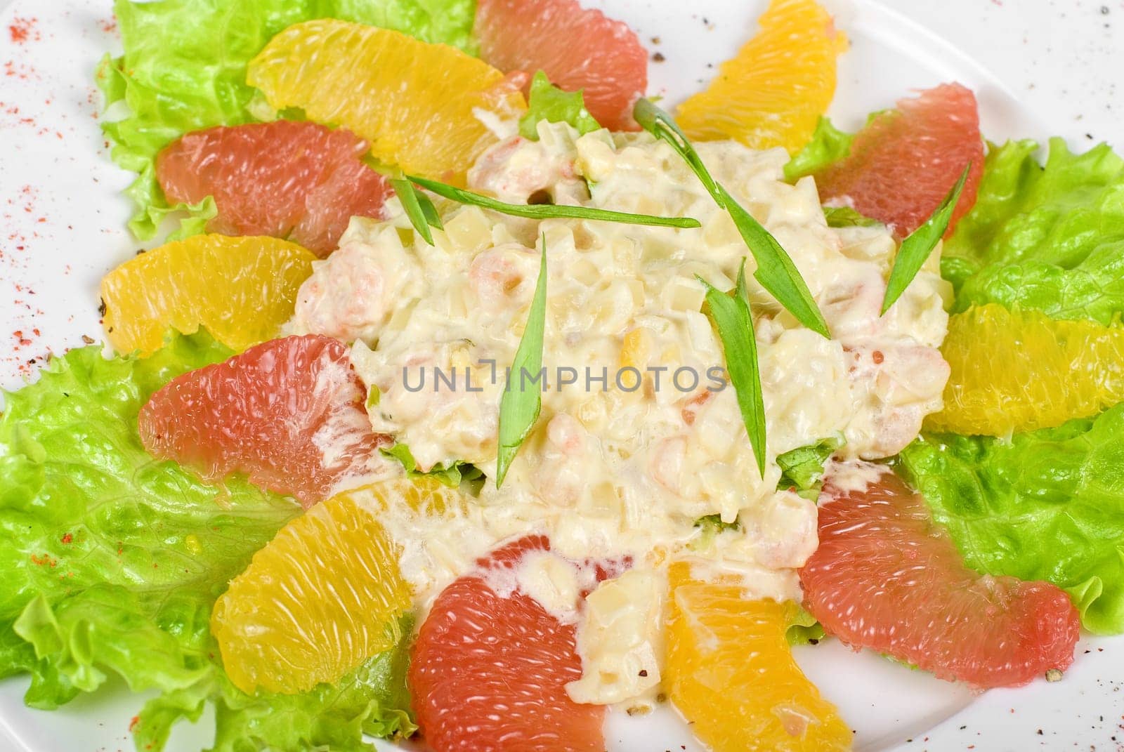seafood salad of shrimp baked at cream with orange and grapefruit isolated on a white background