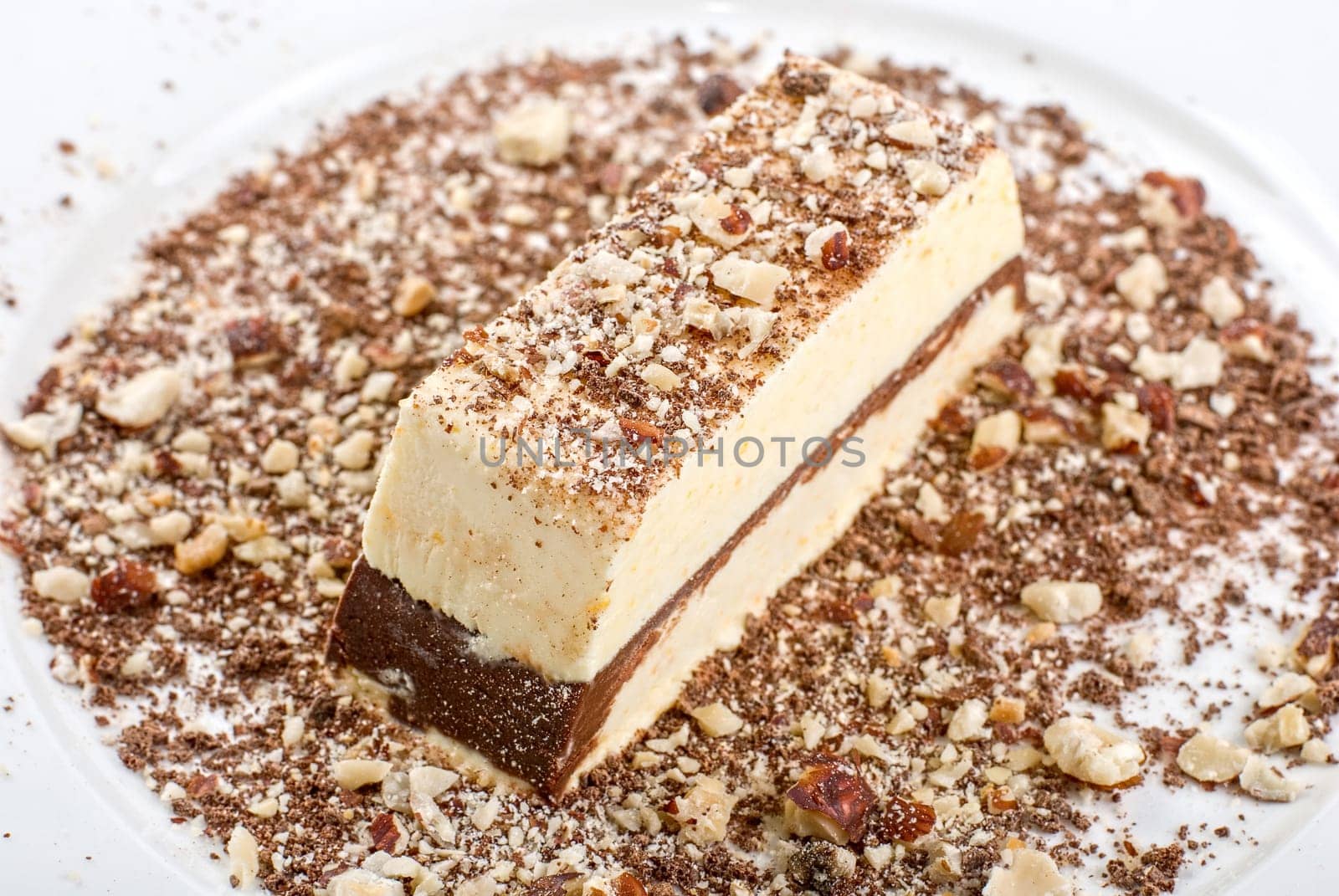 Slice of chocolate cake with nuts isolated on white