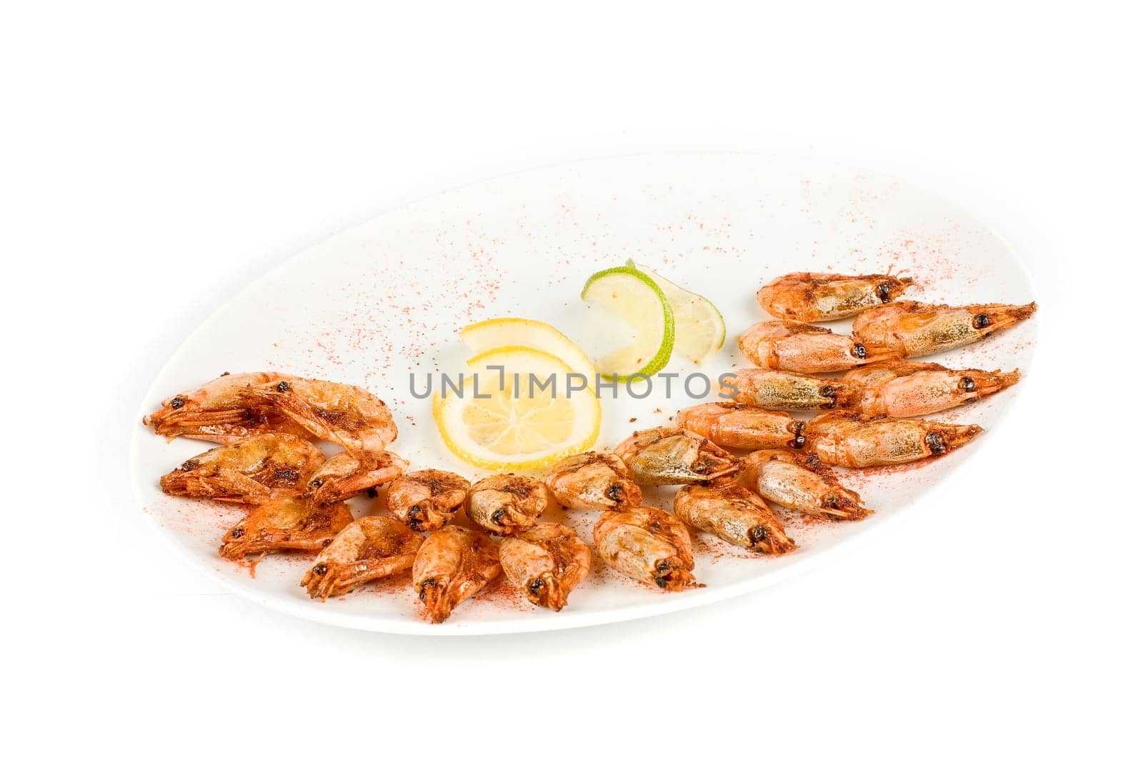 roasted shrimps with lemon closeup isolated on a white background