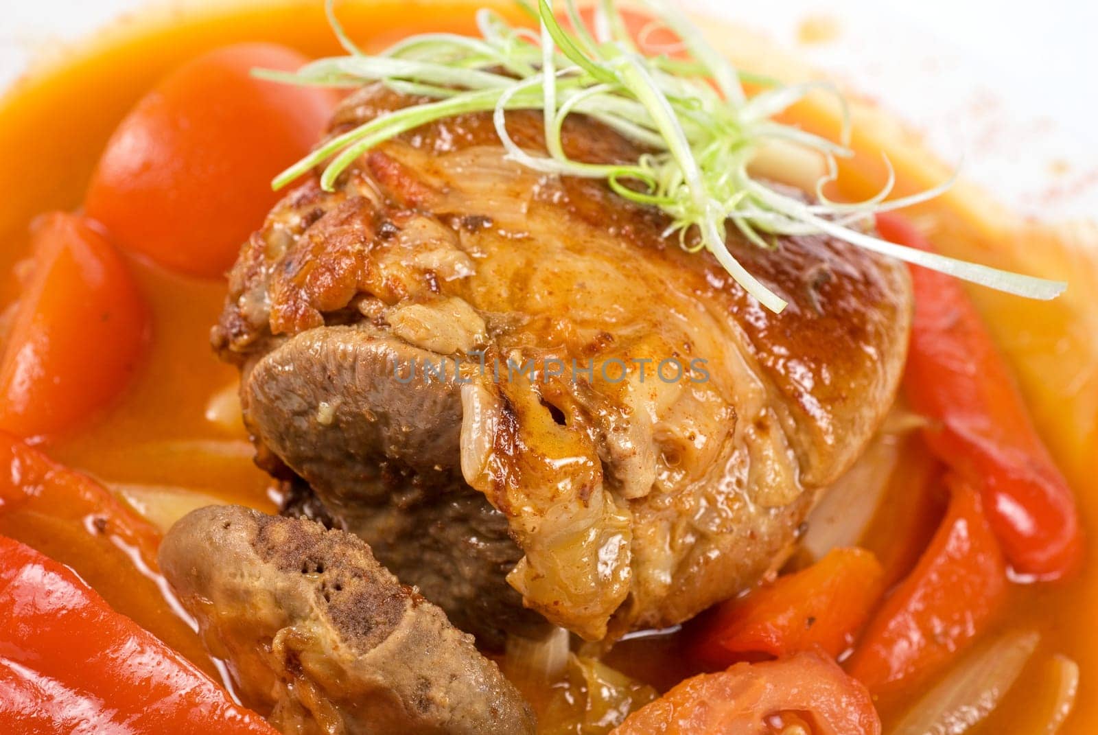 knuckle of veal baked with vegetables closeup