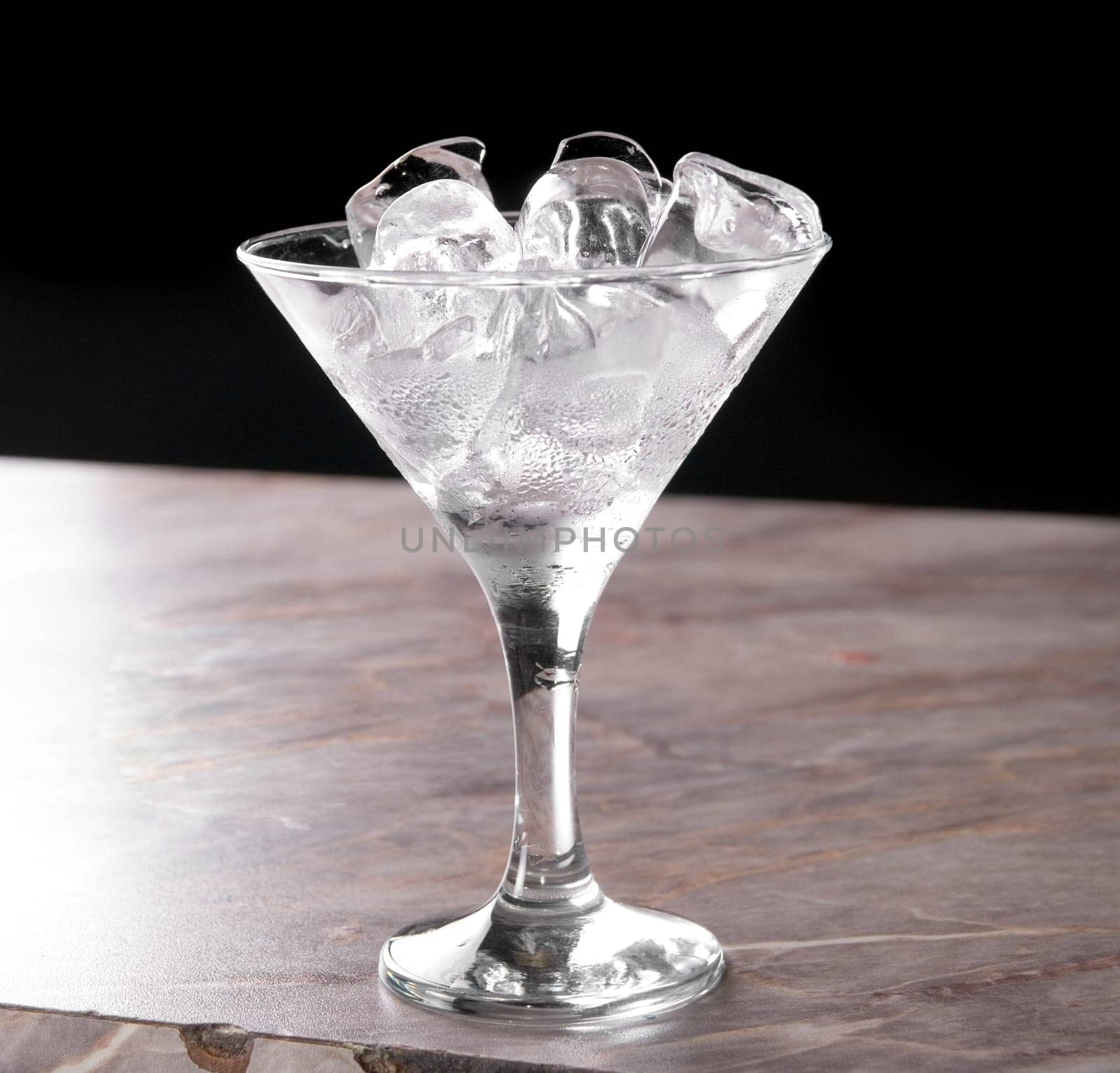 ice at cocktail glass at bar table
