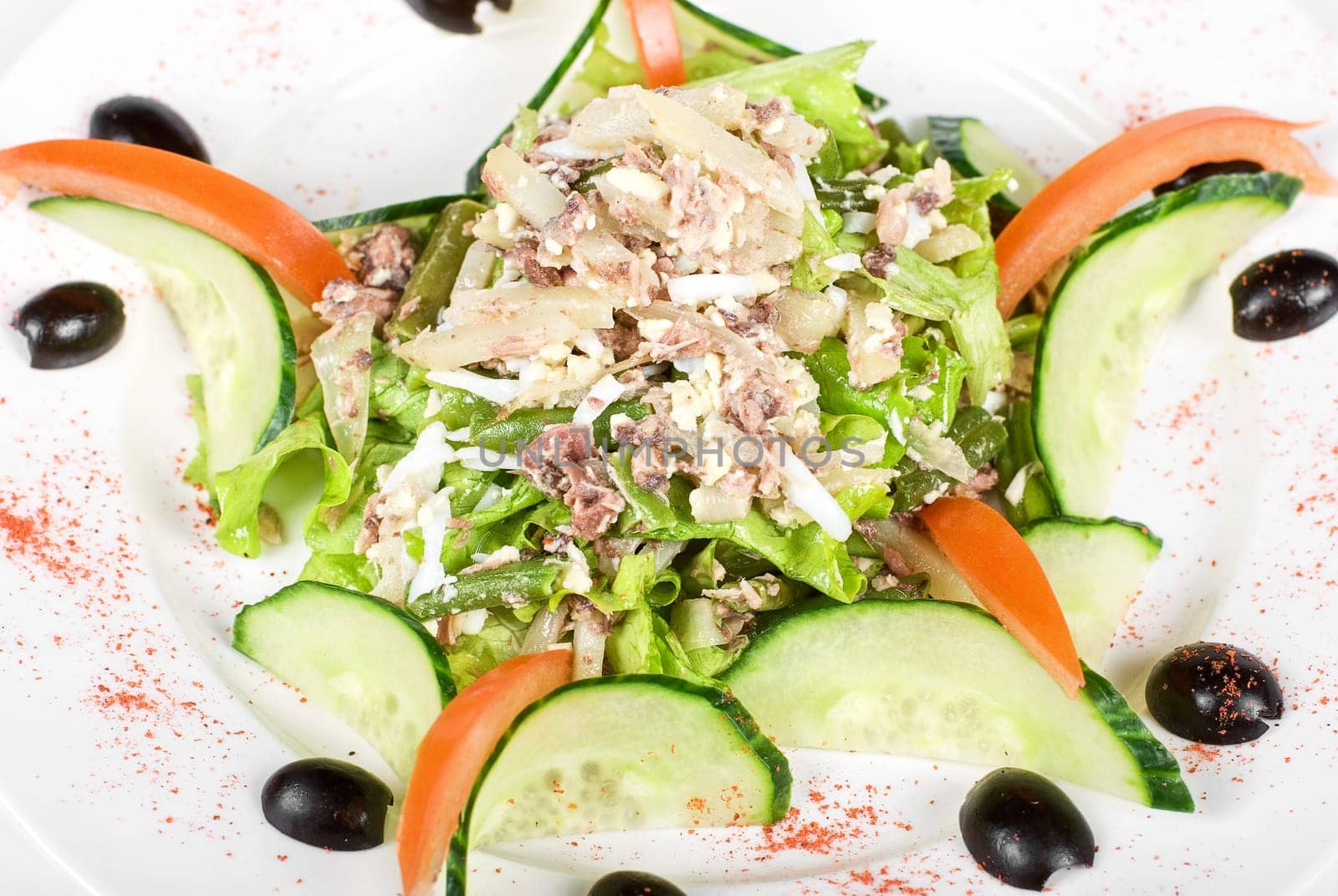 Salad of tuna fish with string beans, eggs, lettuce, boiled potato and fresh cucumbers and tomato