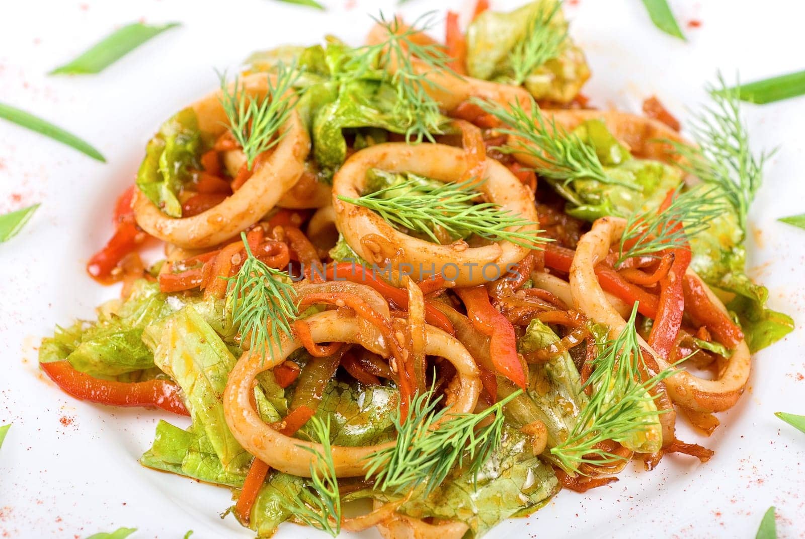 Seafood salad with squid and vegetables close up
