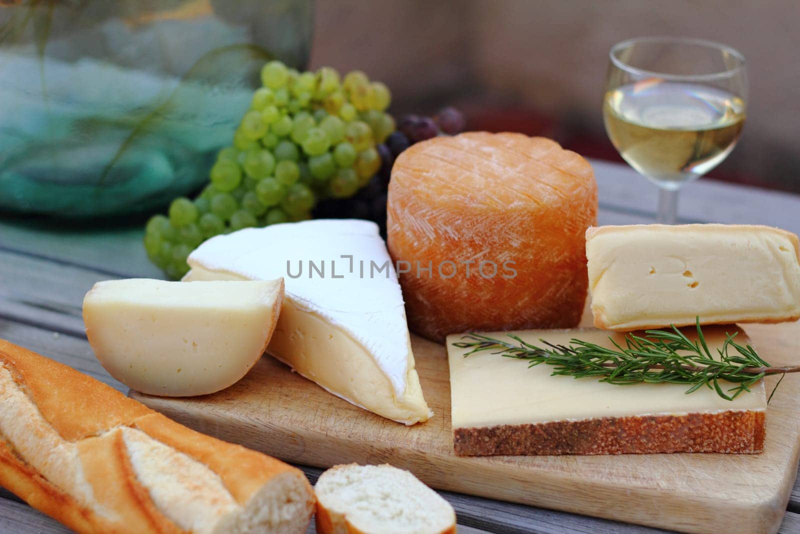 Cheese platter with wine,grapes and baguette