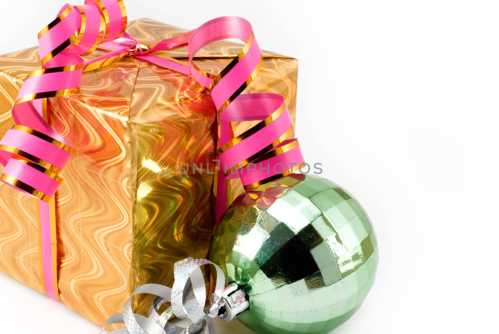 Gift box of yellow color with a pink tape and a brilliant sphere