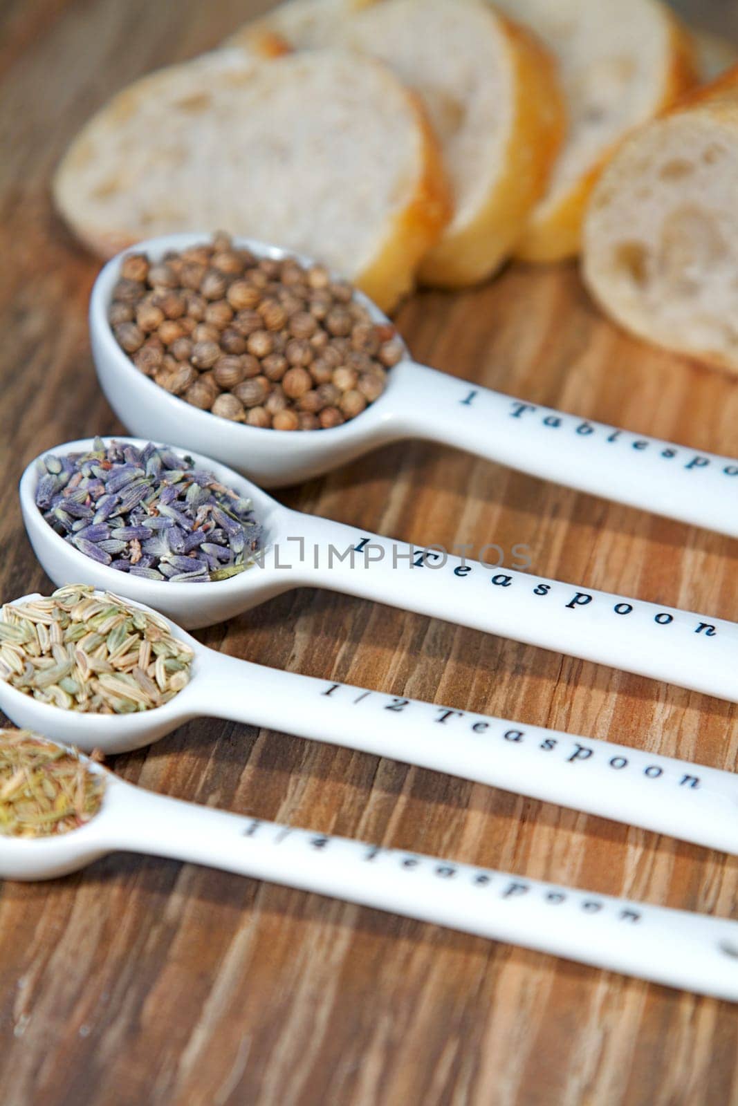 Old table-top selection of herbs and grains in measuring spoons