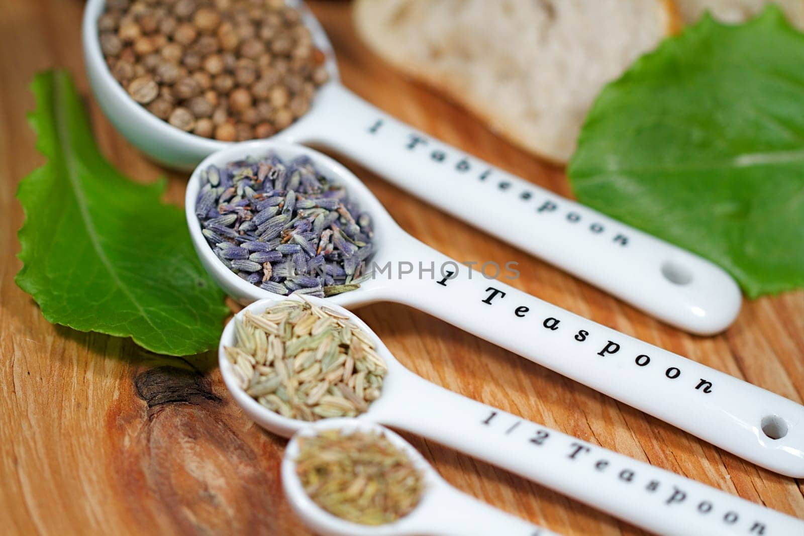 Old table-top selection of herbs and grains in measuring spoons