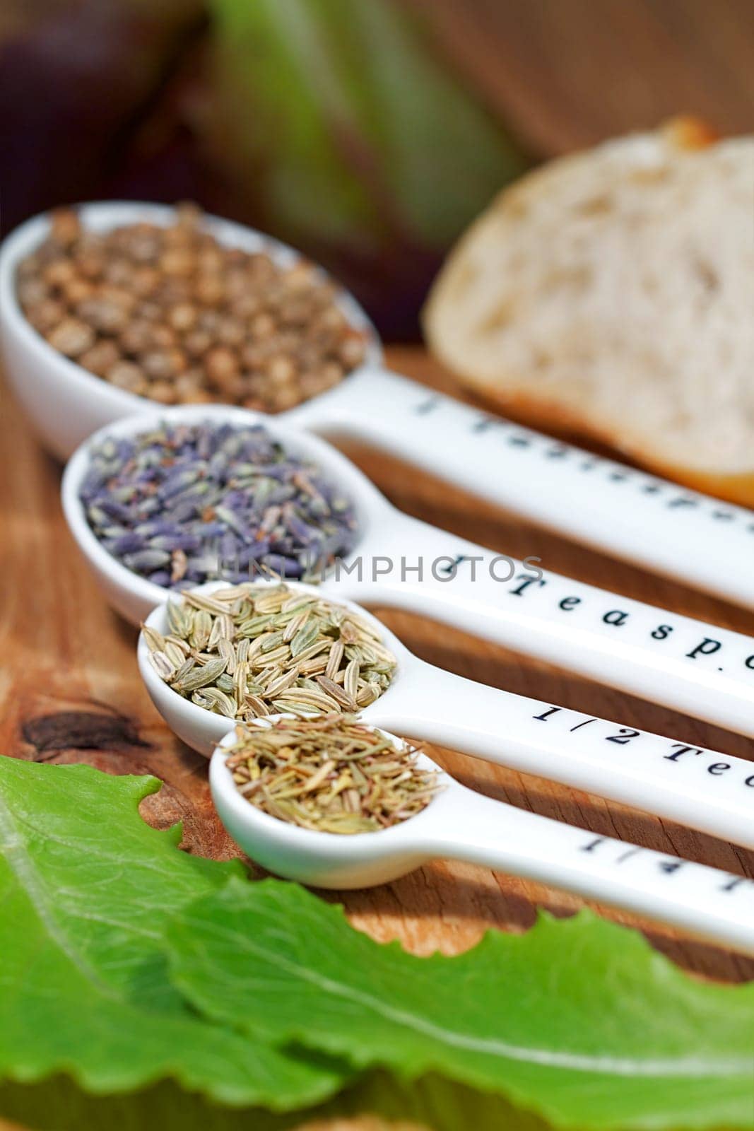 Old table-top selection of herbs and grains in measuring spoons