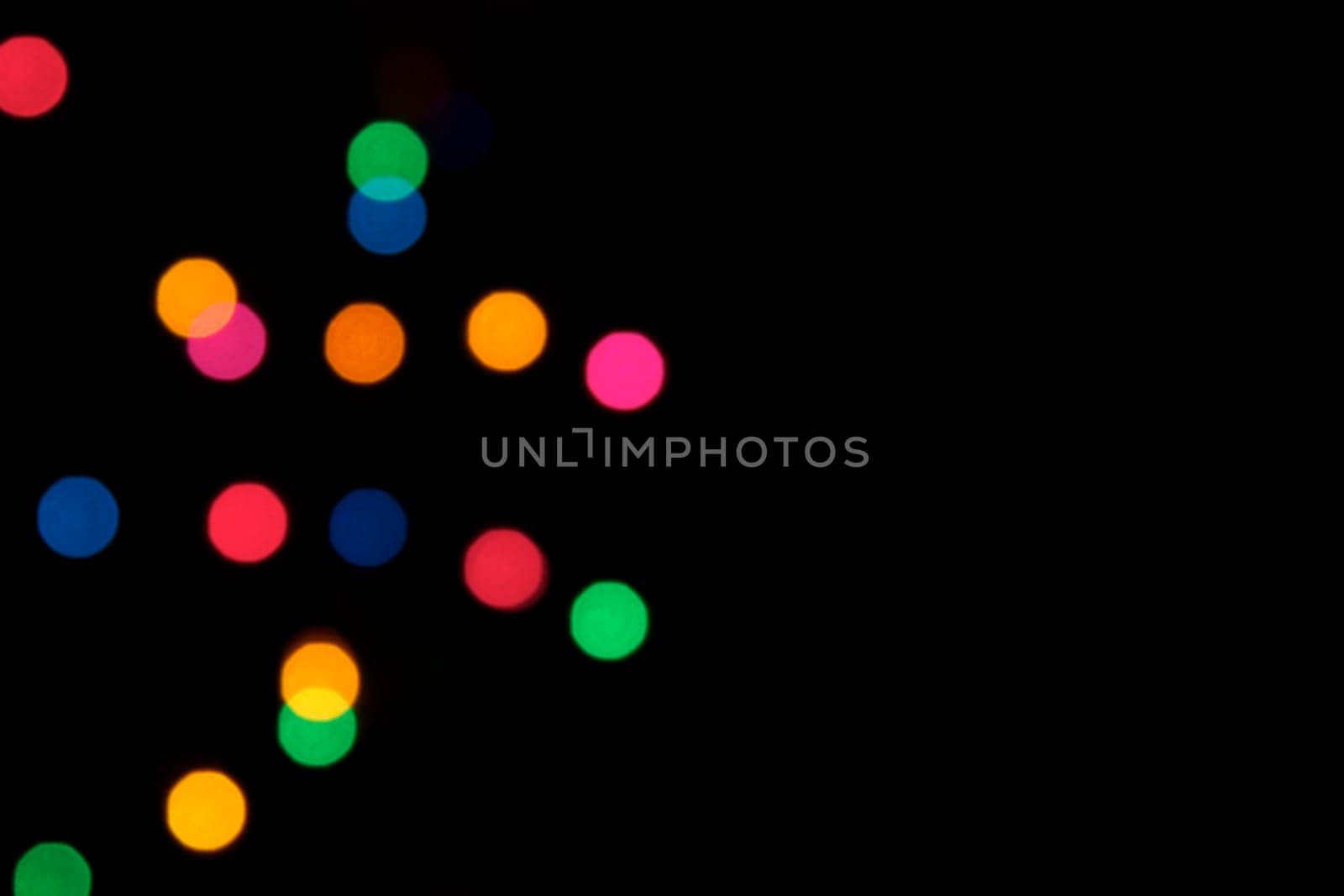 A background of colorful blurred stage lights