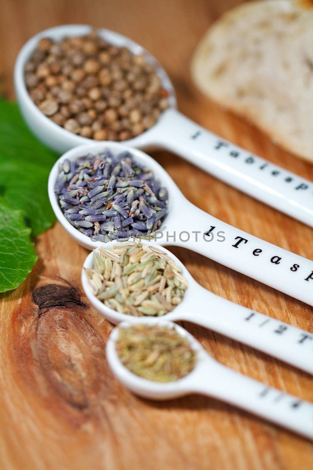 Old table-top selection of herbs and grains in measuring spoons