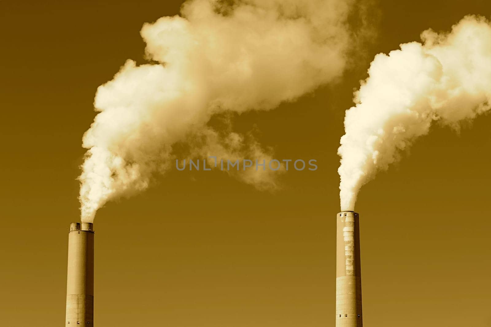 A tall smokestack spewing out dirty polluted smoke