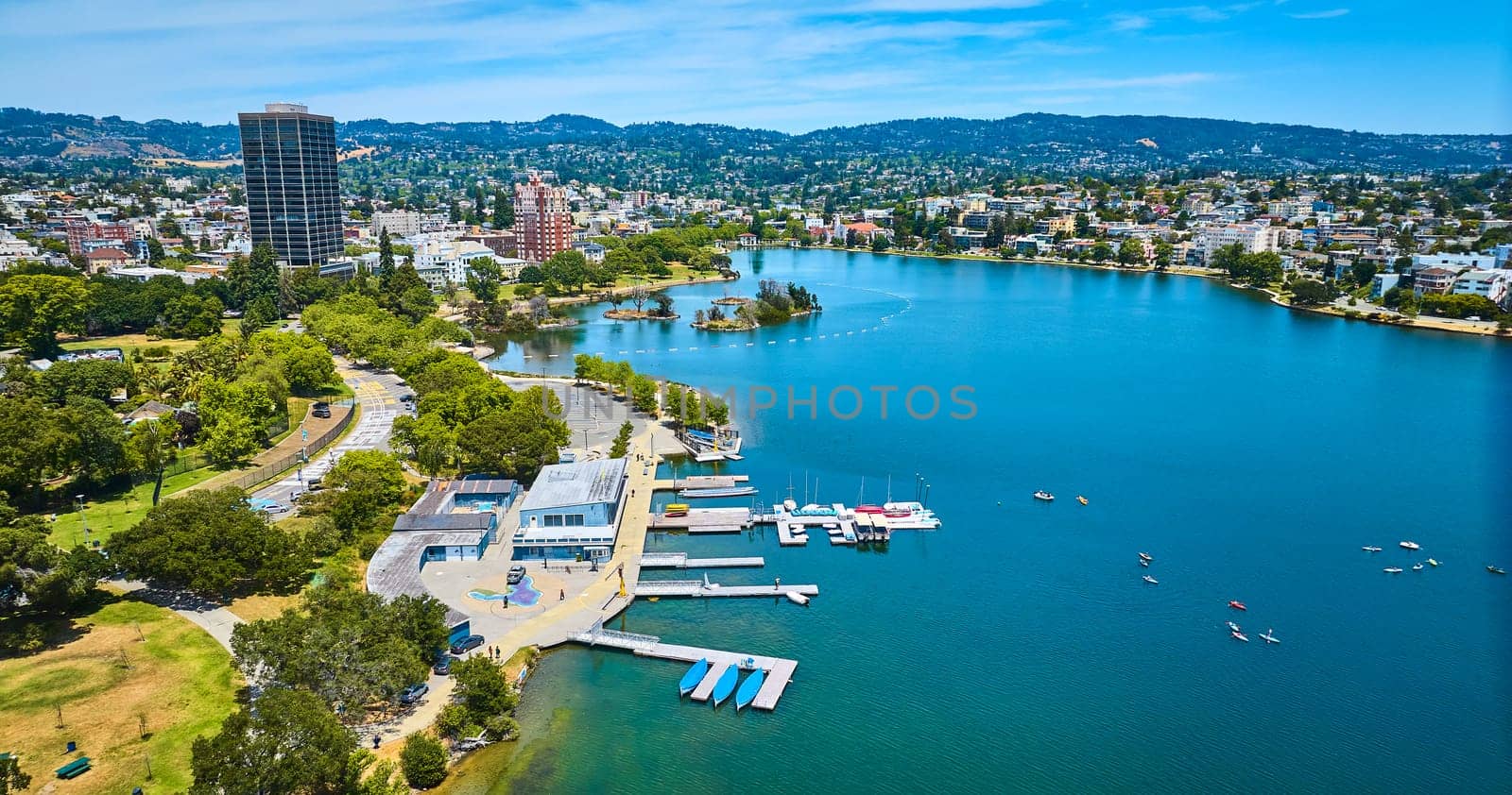Image of Aerial Lake Merritt Boating Center with Pelican Island in distance with buildings along shore