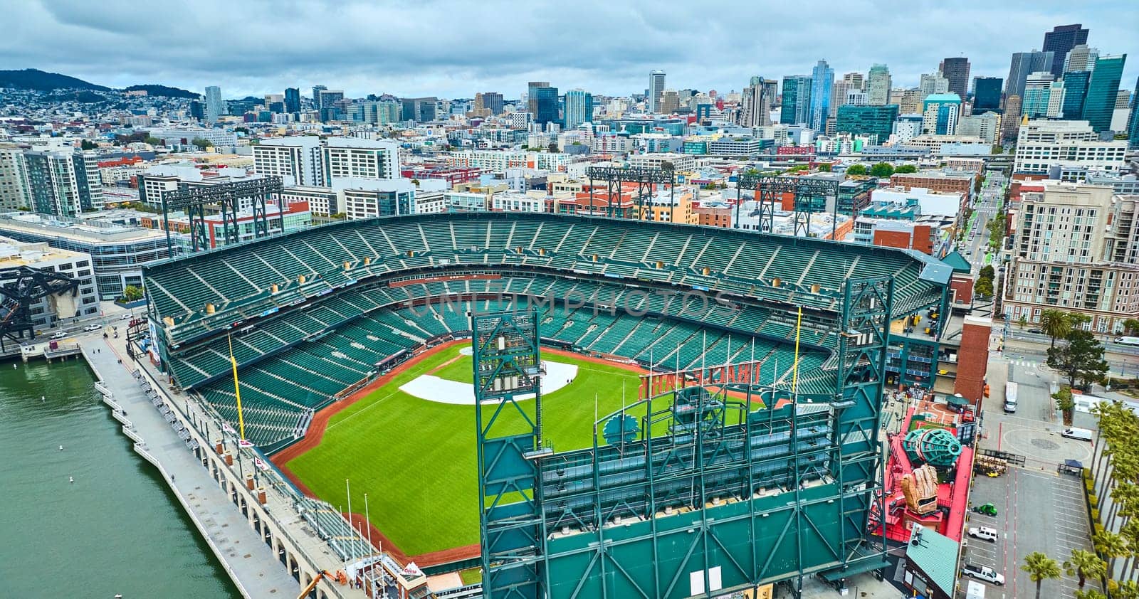 Image of Aerial backside of Oracle Park with coca cola slide and view of city building skyscrapers