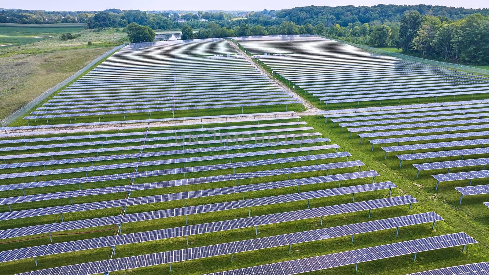 Image of Low aerial view of horizontal solar panel rows