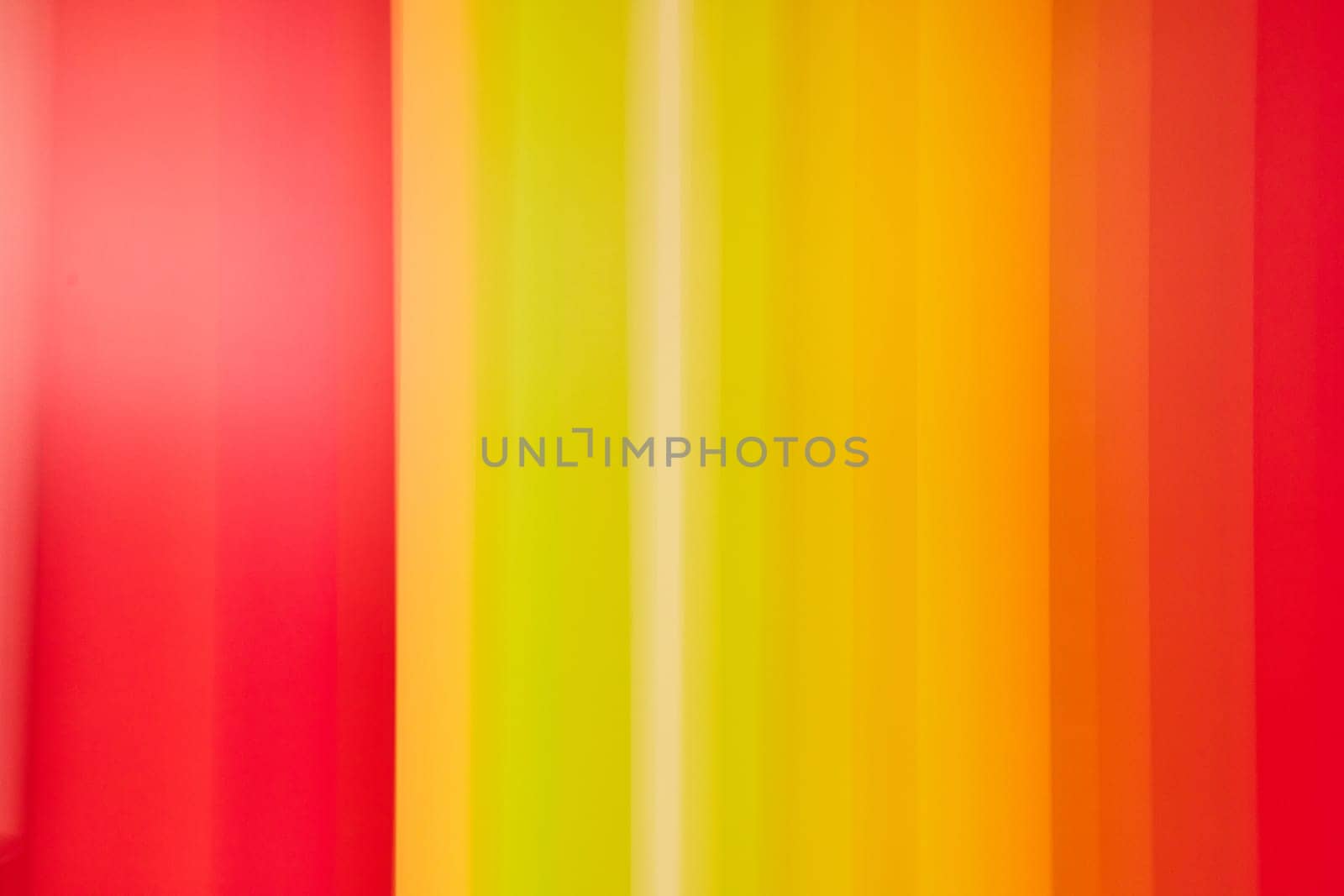 Image of Vertical yellow colored lines fading from orange to red on outer edges abstract background asset