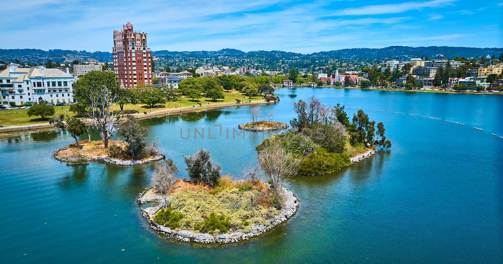 Image of Pelican Island on Lake Merritt with low aerial of Oakland City residential area