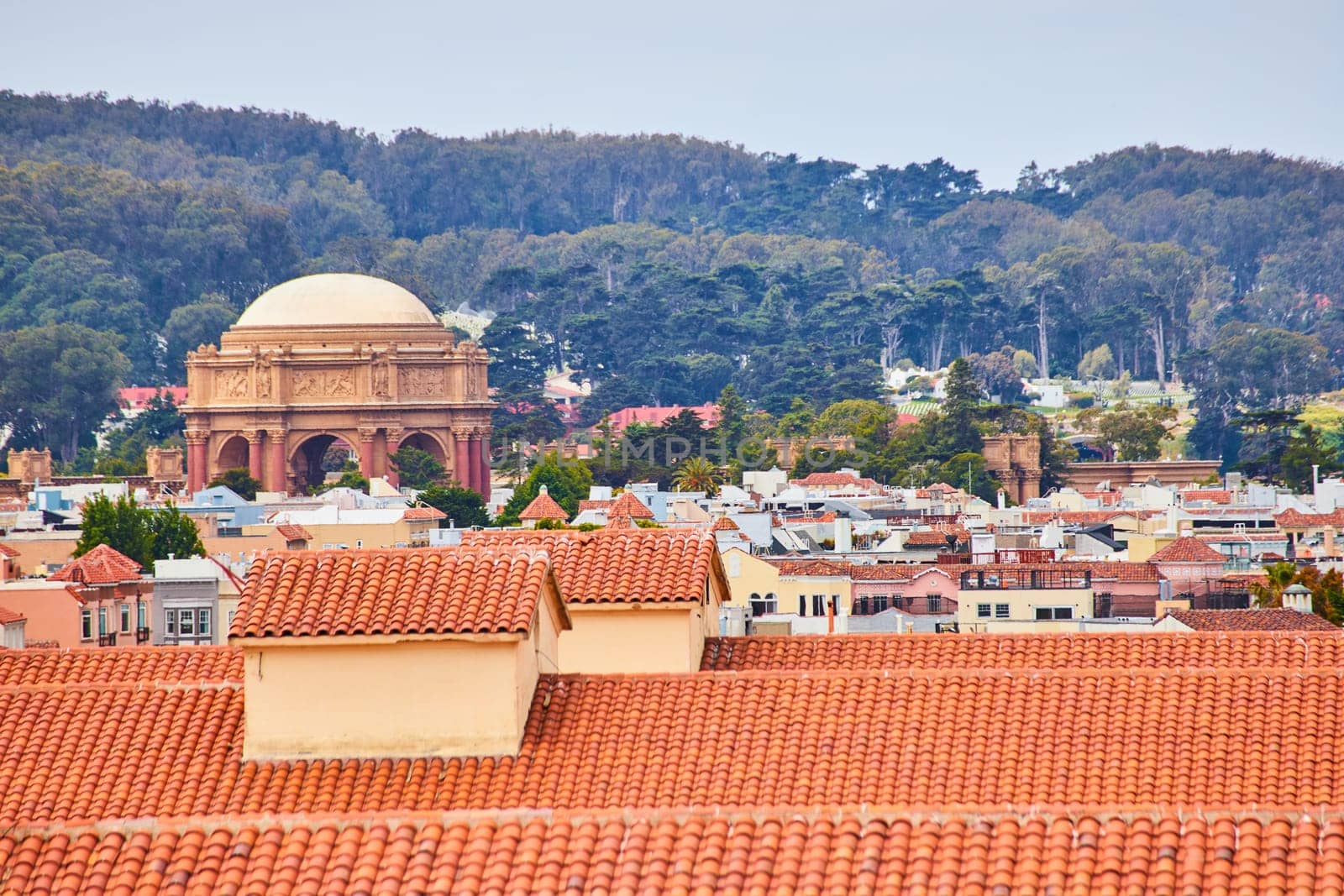 Image of Orange rooftop tiles overlooking buildings leading to Palace of Fine Arts Roman architecture