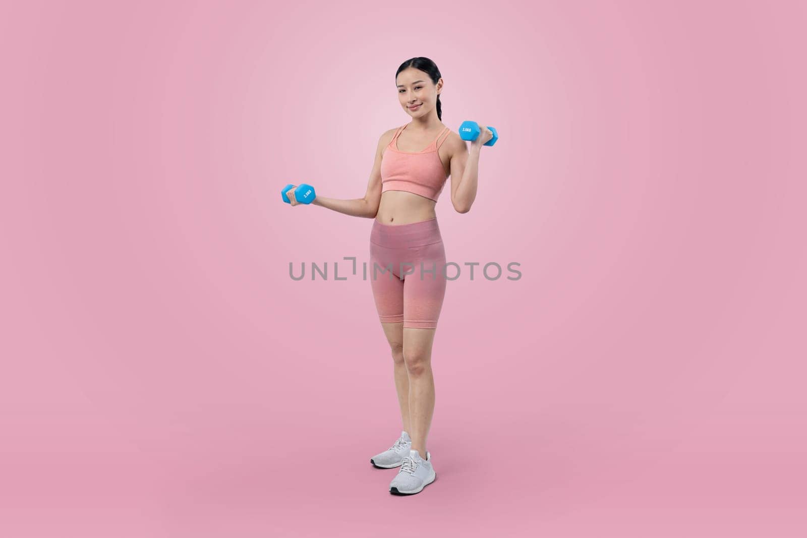 Vigorous energetic woman doing yoga with dumbbell weight exercise. by biancoblue