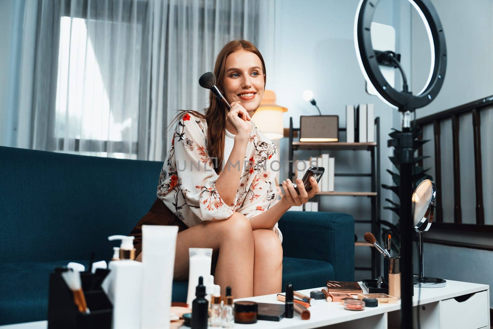 Woman influencer shoot live streaming vlog video review makeup utmost social media or blog. Happy young girl with cosmetics studio lighting for marketing recording session broadcasting online.