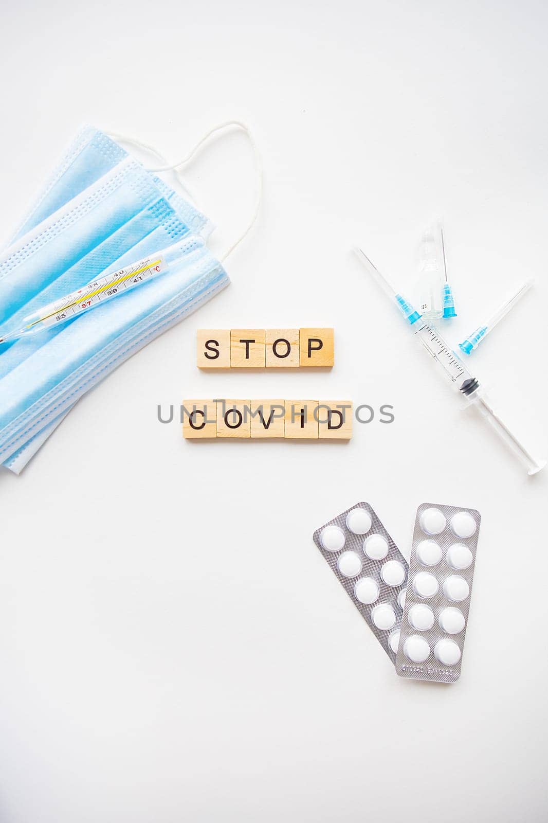 Stop coronavirus inscription. Preparation for vaccination against covid-19. Syringe, vaccine, pills, medical mask