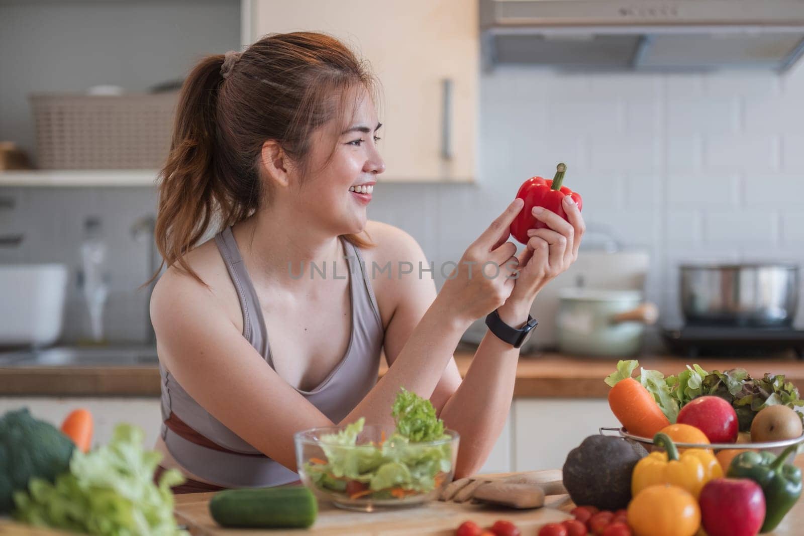 Sporty young woman is preparing healthy food on light kitchen. healthy food concept. by wichayada