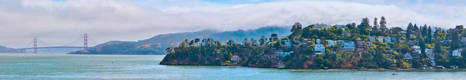 Panorama California Tiburon coastline with Golden Gate Bridge and clouds rolling over mountains by njproductions