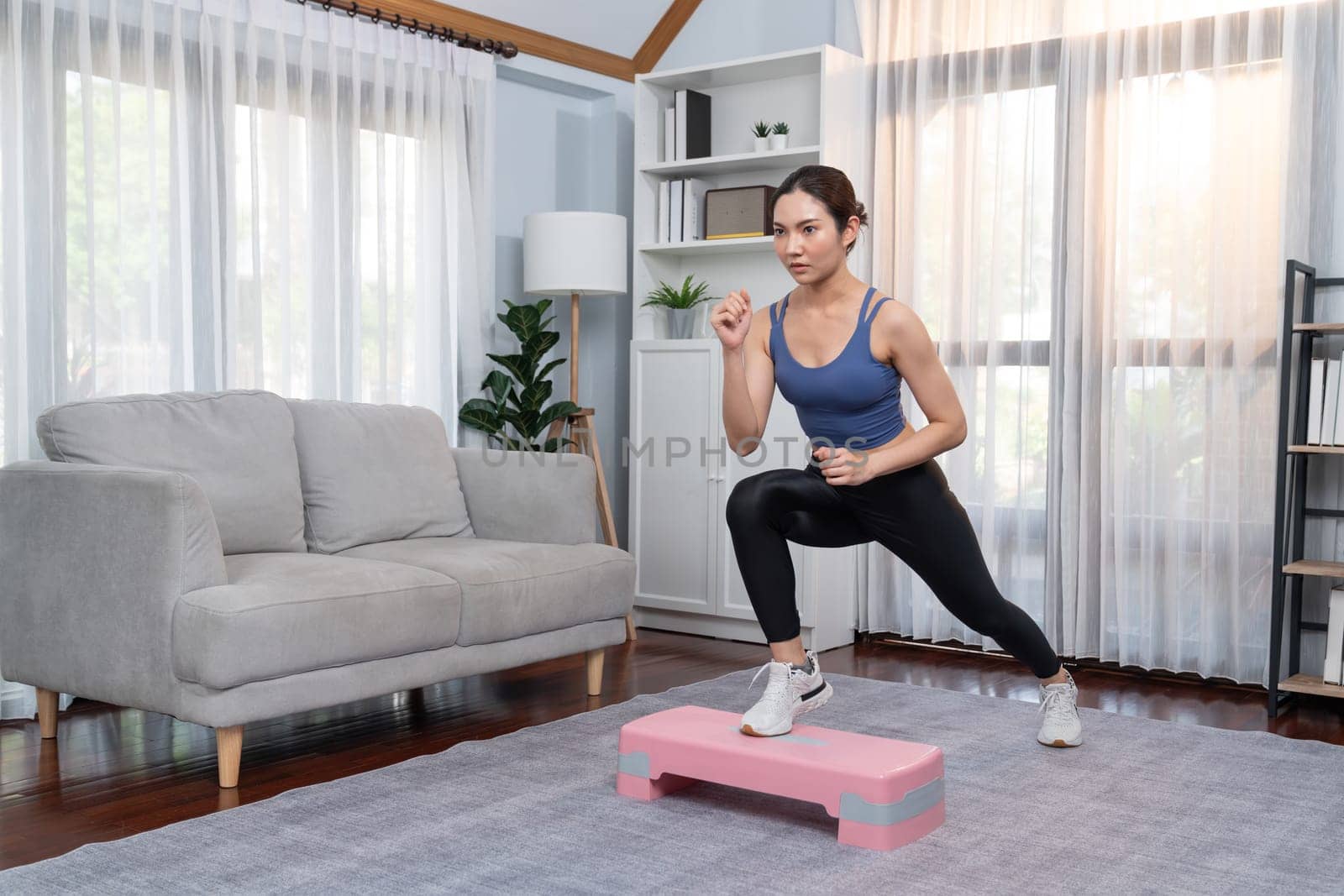 Vigorous energetic woman doing exercise at home with sport. by biancoblue