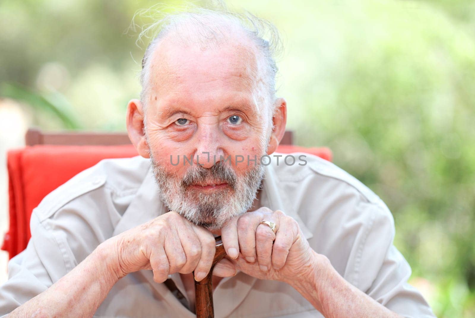 healthy happy old age senior man leaning on walking stick