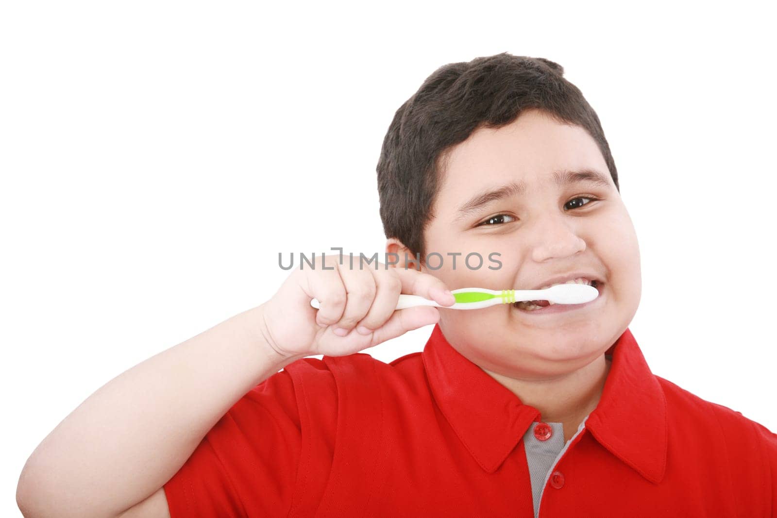 Beautiful boy brushing teeth, isolated on white