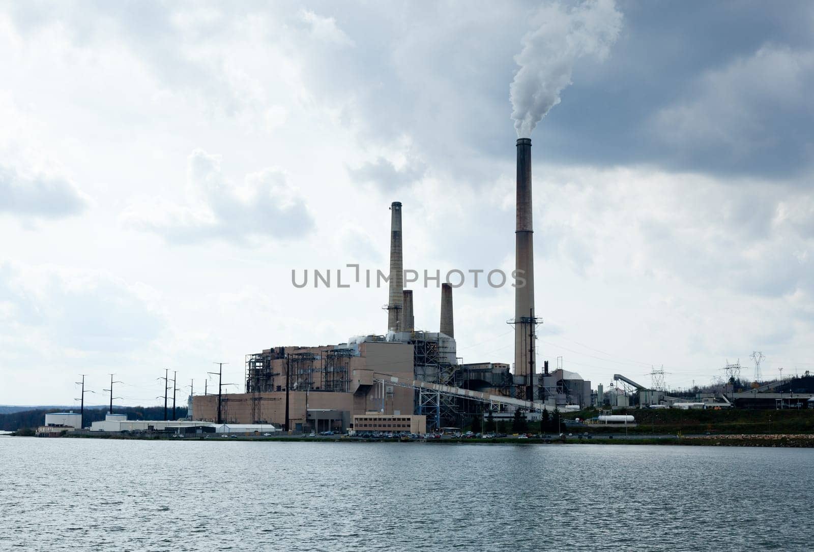 Coal fueled electricity power station by the side of a lake