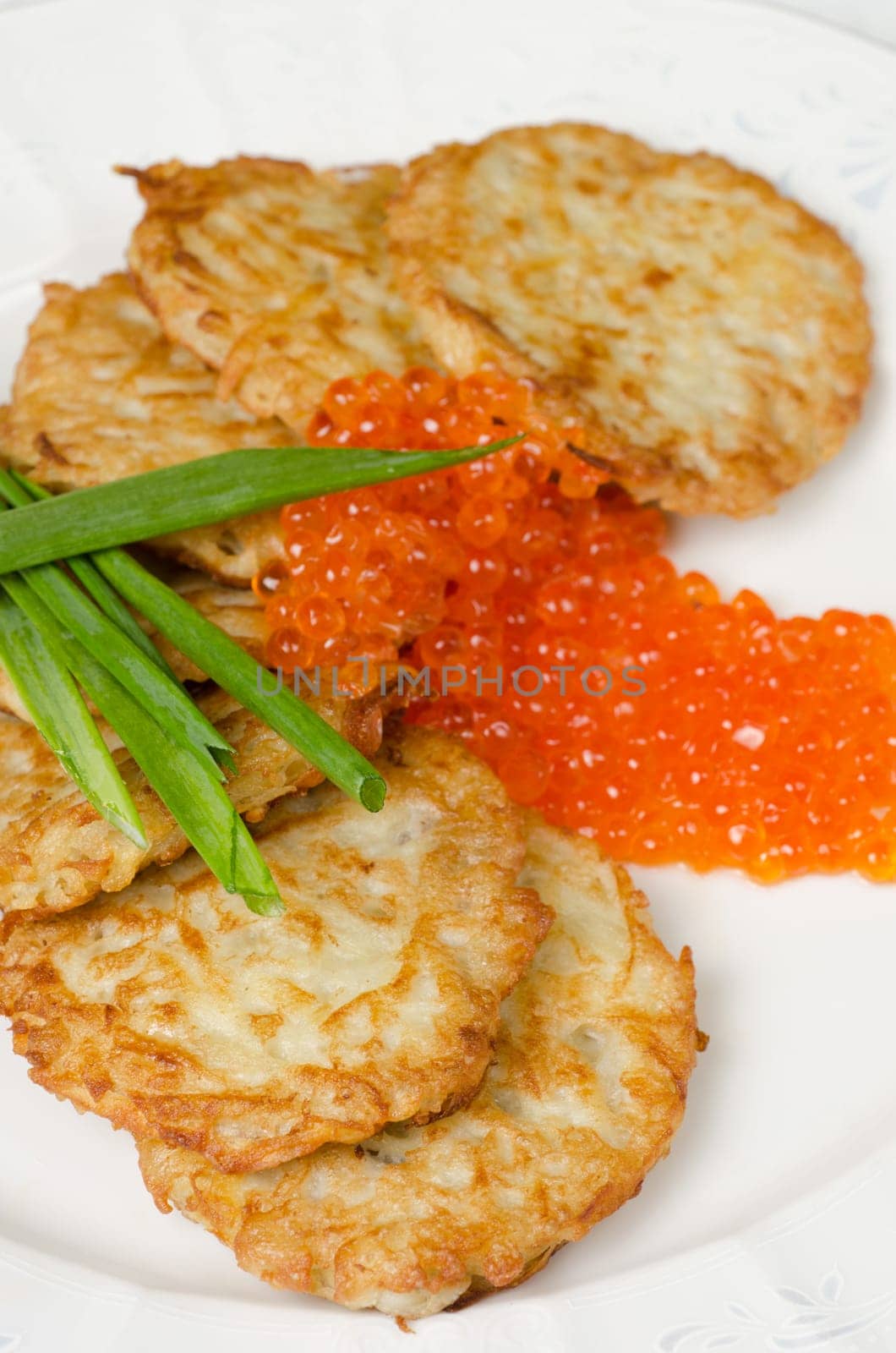 pancakes with red caviar and green onion closeup dish