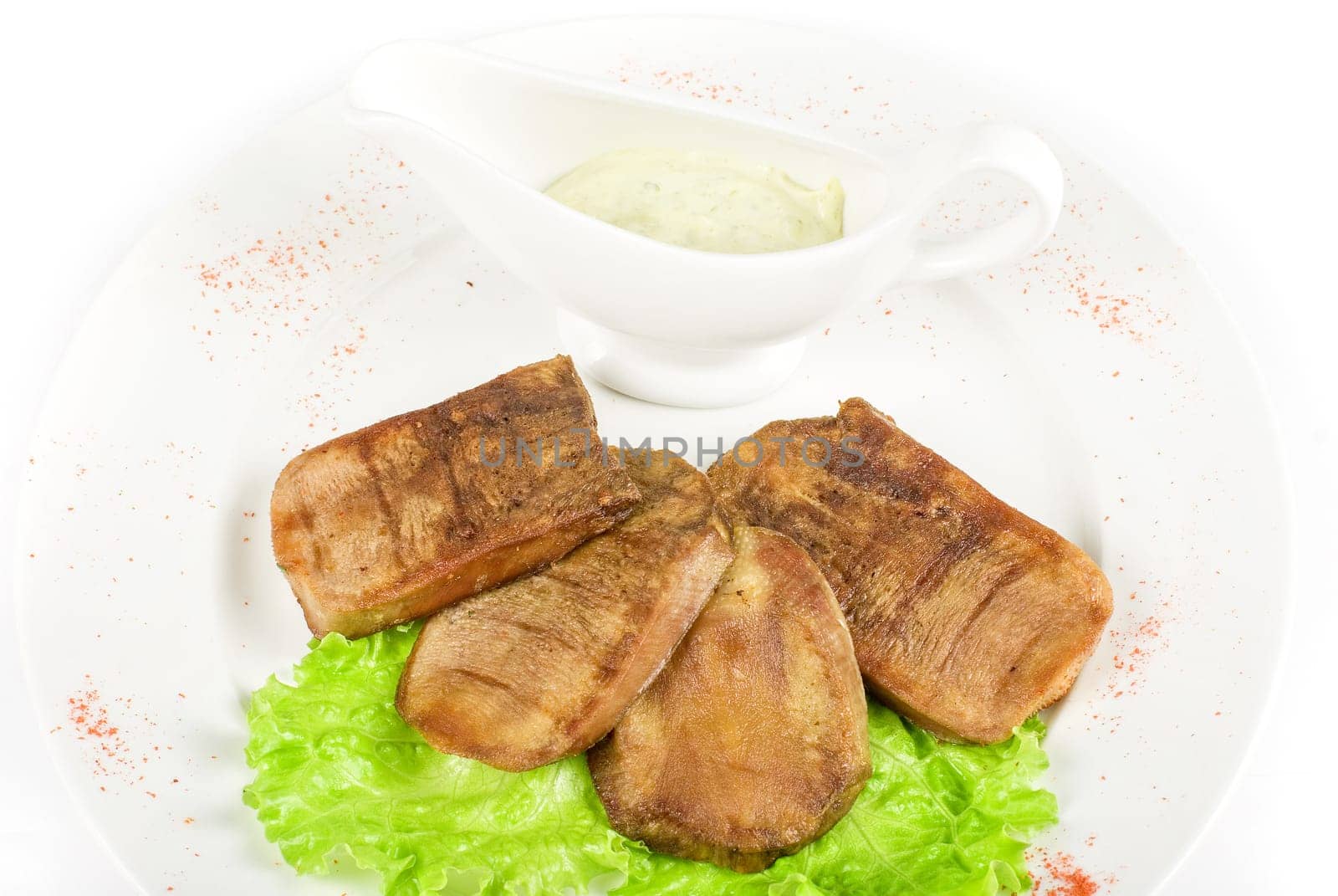 Beef tongue closeup with sauce isolated on a white background