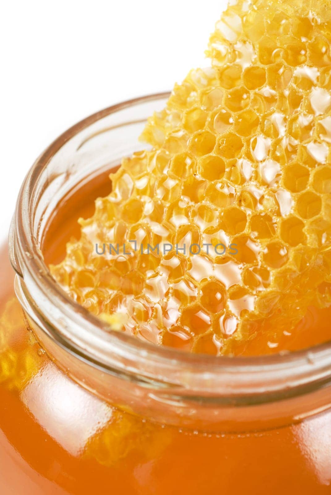 jar of organic honey on white background