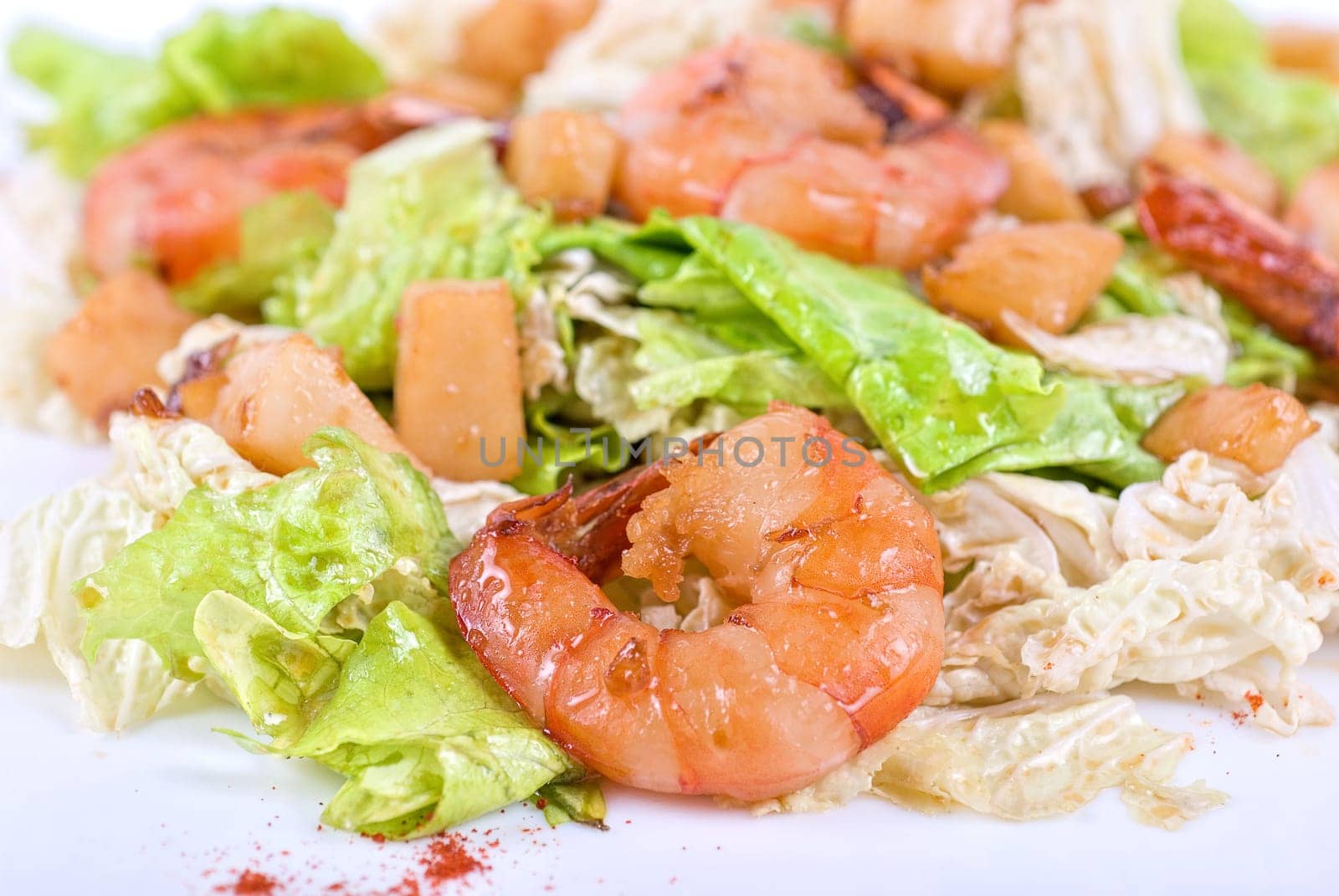 Salad with tiger shrimps and vegetable closeup