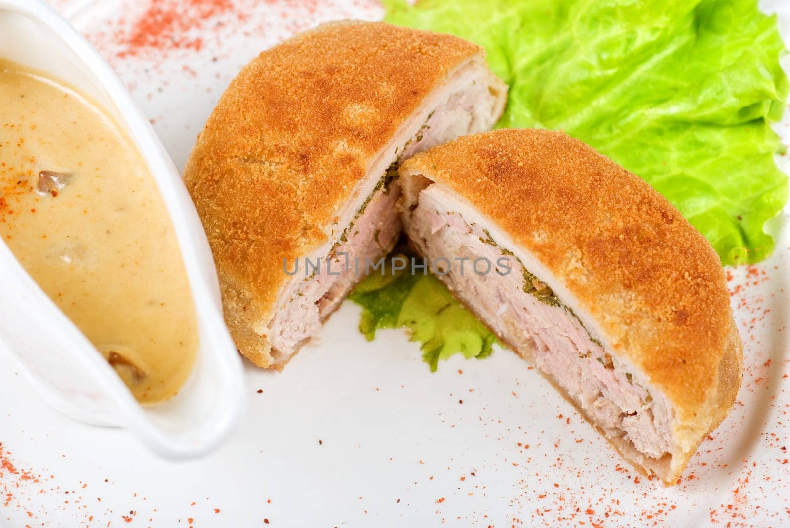 Beef cutlet closeup stuffed with bacon on white plate