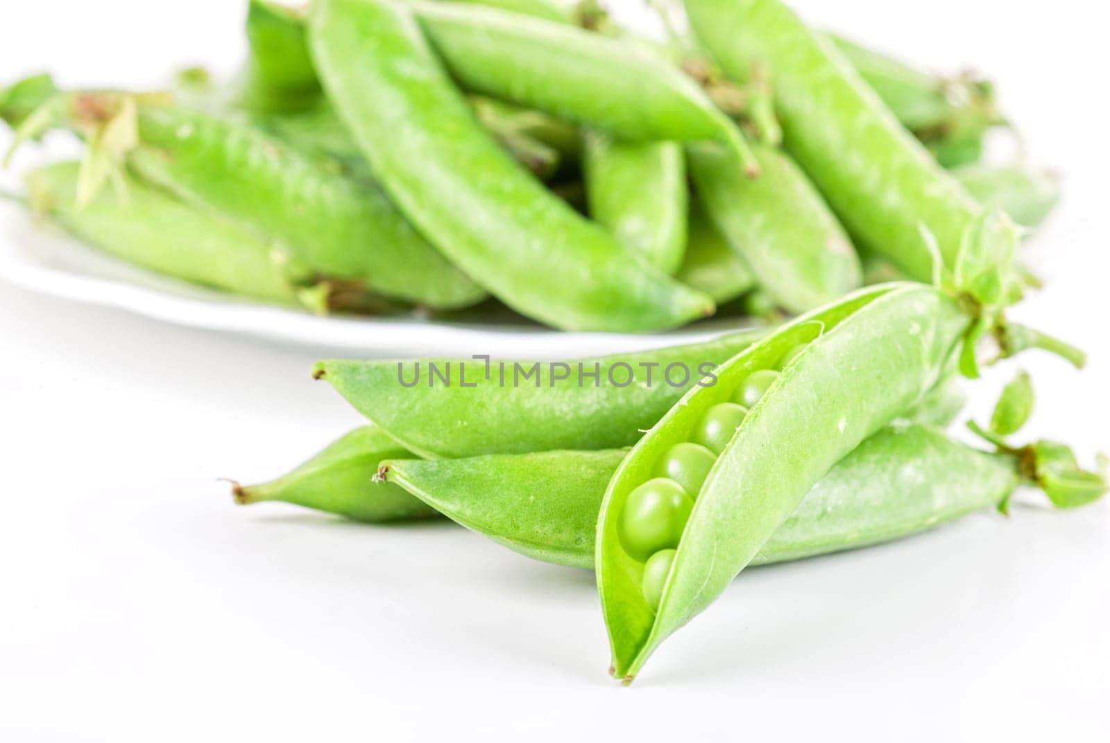 Ripe pea vegetable with green leaf isolated on white background