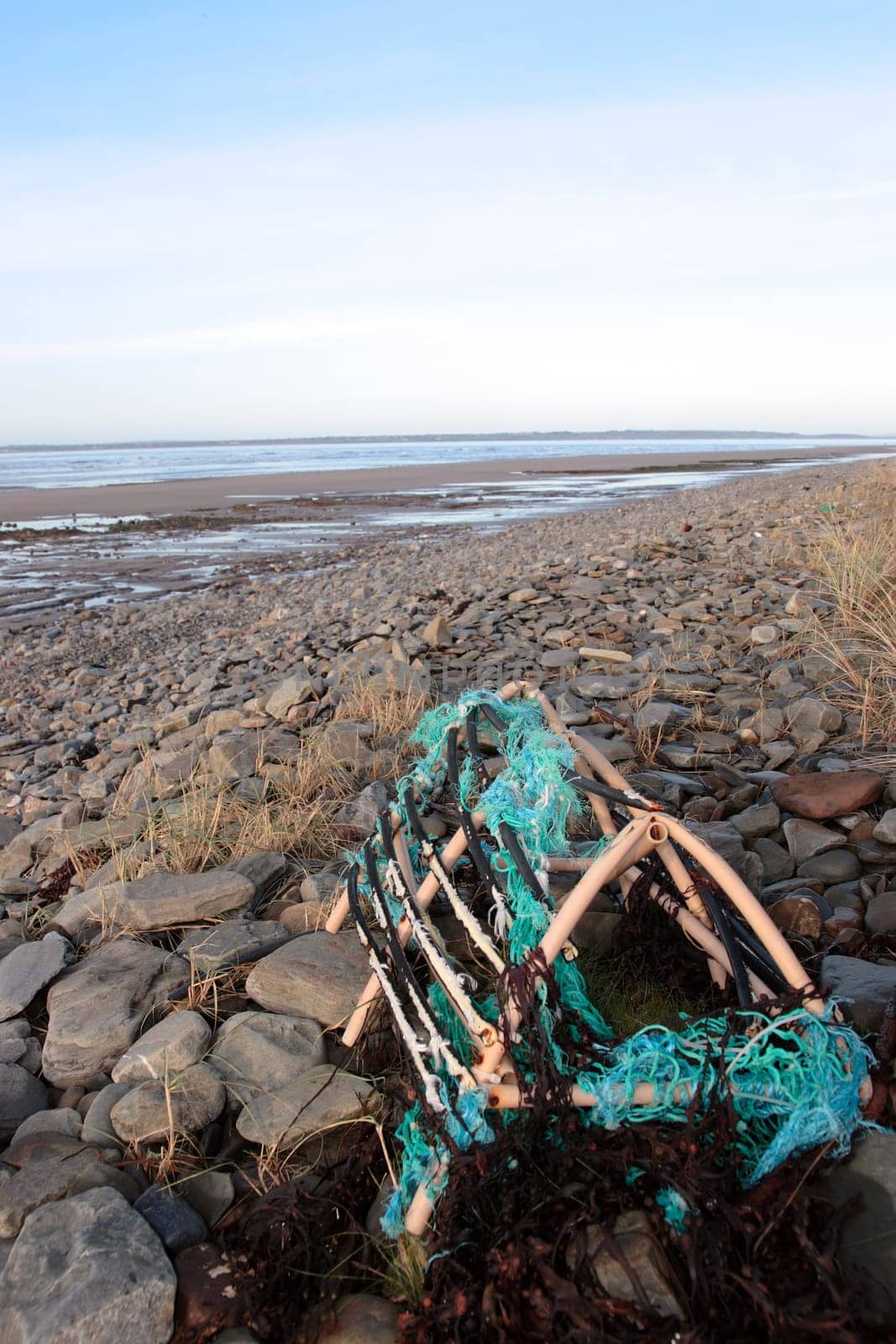 a lobster pot on a rocky irish beach on the west coast