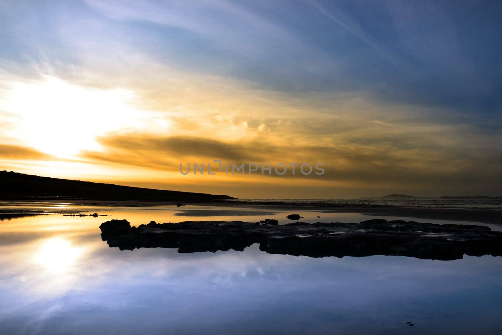 mud and rocks on beale beach co kerry ireland on a beautiful cold winters day