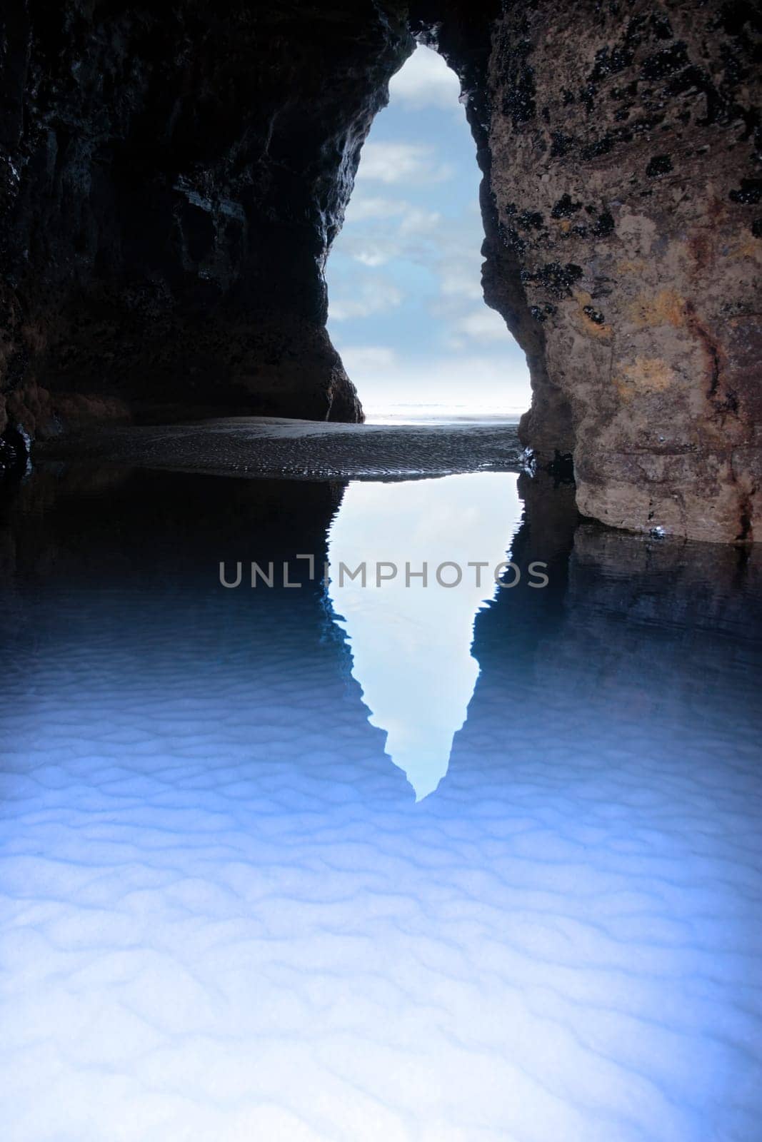 a view from the inside of a beach cave looking out at the sea